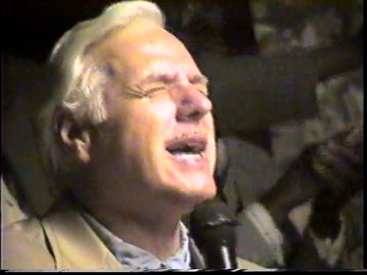 Rev. Steven A. Bach preaching with a microphone